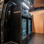 Side van view of the bulkhead section of the Kia PV5 Cargo Makita Makpac Toolbox Compatible Van Racking (x3 V1) displayed with Makita toolboxes and top tray