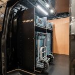 Side van view of the bulkhead section of the Kia PV5 Cargo Makita Makpac Trolley Compatible Van Racking (x3 V1) displayed with Milwaukee toolboxes and trolley