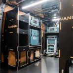 Rear van NS angle view of the Kia PV5 Cargo Makita Makpac Trolley Compatible Van Racking (x3 V1) displayed with Milwaukee toolboxes and trolley