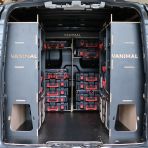 Rear van view of the Kia PV5 Cargo Milwaukee Packout Toolbox Compatible Van Racking (x3 V1) displayed with Milwaukee toolboxes and top trays