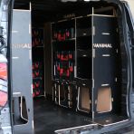 Rear van OS angle view of the Kia PV5 Cargo Milwaukee Packout Toolbox Compatible Van Racking (x3 V1) displayed with Milwaukee toolboxes and top trays