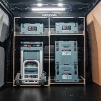 Rear van view of the Kia PV5 Cargo Makita Makpac Trolley Compatible Van Racking - Bulkhead displayed with Makita toolboxes, trolley and top tray