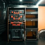 Side van view of the Kia PV5 Cargo Milwaukee Packout Trolley Compatible Van Racking - Front displayed with Milwaukee toolboxes, trolley and top tray