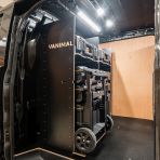 Side van angle view of the Kia PV5 Cargo DeWalt ToughSystem Trolley Compatible Van Racking - Bulkhead displayed with DeWalt ToughSystem toolboxes and trolley