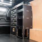 Rear van side angle view of the Kia PV5 Cargo DeWalt ToughSystem Toolbox Compatible Van Racking - Front displayed with DeWalt ToughSystem toolboxes and top tray