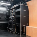 Rear van side angle view of the Kia PV5 Cargo DeWalt ToughSystem Trolley Compatible Van Racking - Front displayed with DeWalt ToughSystem toolboxes, trolley and top tray