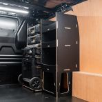 Rear van side angle view of the Kia PV5 Cargo DeWalt ToughSystem Trolley Compatible Van Racking - Front displayed with DeWalt ToughSystem toolboxes and trolley