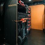 Side van view of the Kia PV5 Cargo Milwaukee Packout Trolley Compatible Van Racking - Bulkhead displayed with Milwaukee toolboxes and trolley