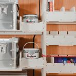 Close-up view of the seamless fit of the Transit Custom 2023- SWB Adjustable Driver Side Racking + 3 Predator Storage Boxes