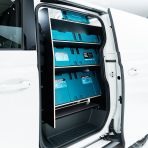 Passenger side angle view of the Proace City Long NS Hexaboard Van Racking: Compartment & Side Load Shelving - makita boxes displayed