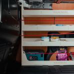 Side van view of the Renault Kangoo II 2008-2021 SWB OS/Driver Side Racking with Multi-Compartment Shelving