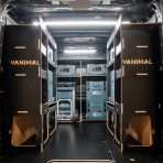 Rear van view of the Kia PV5 Cargo Makita Makpac Trolley Compatible Van Racking (x3 V1) displayed with Milwaukee toolboxes, trolley and top trays