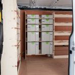 Modular premium plywood bulkhead and driver‑side Festool shelving system