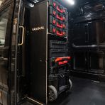 Side van view of the VW Crafter 2017+ Milwaukee Packout Trolley Compatible Van Racking - Bulkhead displayed with Milwaukee toolboxes and trolley