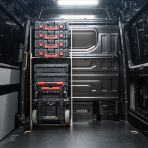 Rear van view of the VW Crafter 2017+ Milwaukee Packout Trolley Compatible Van Racking - Bulkhead displayed with Milwaukee toolboxes and trolley