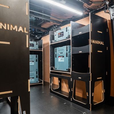 Rear van OS angle view of the Kia PV5 Cargo Makita Makpac Trolley Compatible Van Racking (x3 V1) displayed with Milwaukee toolboxes and trolley