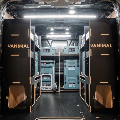 Rear van view of the Kia PV5 Cargo Makita Makpac Trolley Compatible Van Racking (x3 V1) displayed with Milwaukee toolboxes and trolley