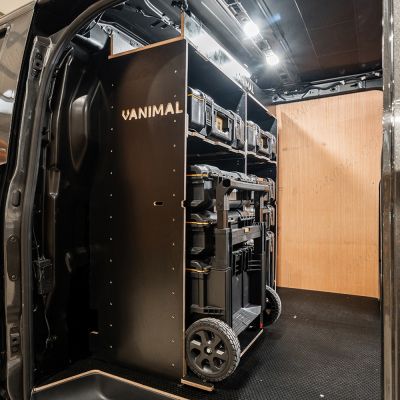 Side van angle view of the Kia PV5 Cargo DeWalt ToughSystem Trolley Compatible Van Racking - Bulkhead displayed with DeWalt ToughSystem toolboxes, trolley and top tray