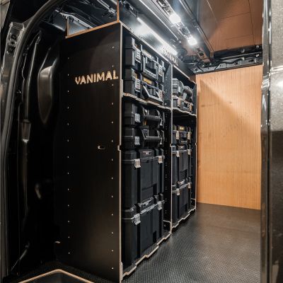 Side van view of the Kia PV5 Cargo DeWalt TSTAK Toolbox Compatible Van Racking - Bulkhead displayed with DeWalt TSTAK toolboxes and top tray