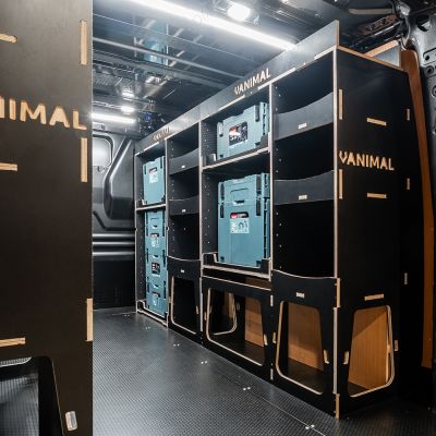 Rear van OS angle view of the Kia PV5 Cargo Makita Makpac Toolbox Compatible Van Racking (x3 V2) displayed with Makita toolboxes and top trays