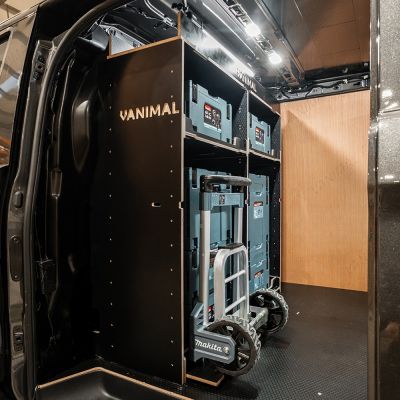 Side van view of the bulkhead section of the Kia PV5 Cargo Makita Makpac Trolley Compatible Van Racking (x3 V1) displayed with Milwaukee toolboxes, trolley and top tray