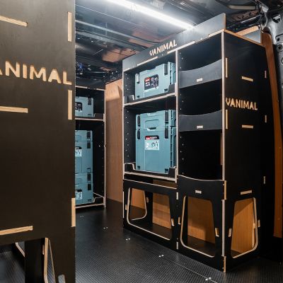 Rear van OS angle view of the Kia PV5 Cargo Makita Makpac Trolley Compatible Van Racking (x3 V1) displayed with Milwaukee toolboxes, trolley and top trays