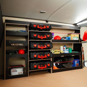 Side van angle view of the VW Transporter T7 Hexaboard Driver Side Ulti-Rack Van Racking V2 displaying Milwaukee equipment, tools and boxes