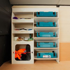 Side van view of the VW Transporter T7 Hexaboard Front Ulti-Rack Van Racking V2 displaying Makita equipment, tools and boxes
