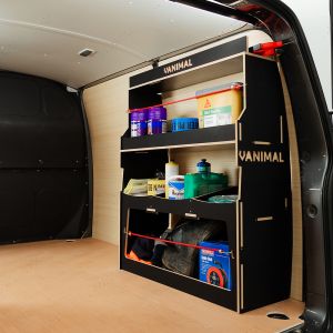 Rear side angle view of the Nissan NV300 2016- Hexaboard Rear Ulti-Rack Van Racking V2 displaying equipment, tools and boxes