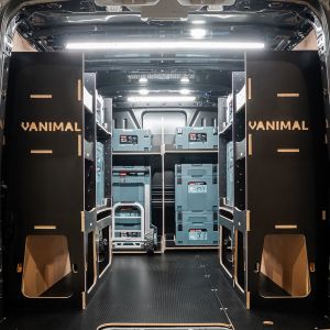 Rear van view of the Ford Transit Custom 2012-2023 Makita Makpac Trolley Compatible Van Racking (x3 V4) displayed with Milwaukee toolboxes and trolley