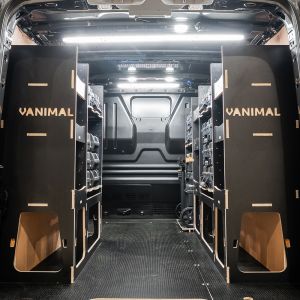 Rear van view of the Ford Transit Custom 2012-2023 L2 DeWalt TSTAK Trolley Compatible Van Racking (x3 V2) displayed with DeWalt TSTAK toolboxes and trolley