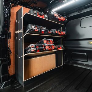 Rear van side angle view of the Ford Transit Custom 2024- LWB Crew Cab NS Milwaukee Toolbox Hexaboard Van Shelving - displayed with Milwaukee boxes