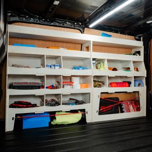 Side van angle view of the Ford Transit Custom 2012-2023 Driver Side Ulti-Rack Van Racking displayed with equipment, tools and boxes