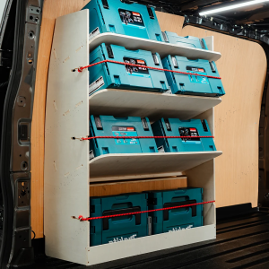 Side angle view of the Ford Transit Custom 2023- SWB NS Rear Toolbox Racking with x3 Angled Shelves displaying makita tools