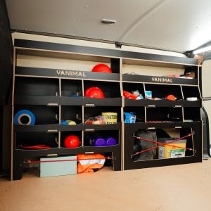 Side van angle view of the VW Transporter T5/T6 Hexaboard Driver Side Ulti-Rack Van Racking displaying equipment, tools and boxes