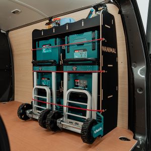 Rear van OS angle view of the Nissan Primastar 2022- L2 Hexaboard OS Rear MakPac/Toolbox Van Racking displayed with Makita toolboxes and trolleys