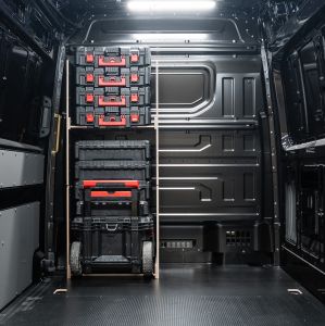 Rear van view of the MAN TGE 2017+ Milwaukee Packout Trolley Compatible Van Racking - Bulkhead displayed with Milwaukee toolboxes and trolley