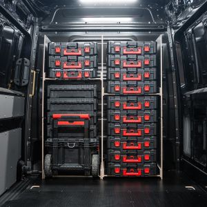 Rear van view of the MAN TGE 2017+ Milwaukee Packout Trolley Compatible Van Racking - Full-Width Bulkhead displayed with Milwaukee toolboxes and trolley