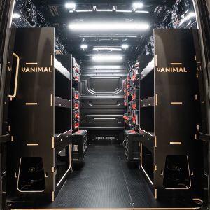 Rear van view of the MAN TGE 2017+ Milwaukee Packout Trolley Compatible Van Racking (x3 V2) displayed with Milwaukee toolboxes and trolley