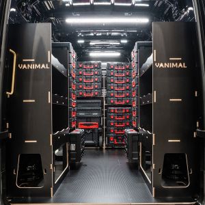 Rear van view of the MAN TGE 2017+ Milwaukee Packout Trolley Compatible Van Racking (x3 V4) displayed with Milwaukee toolboxes and trolley