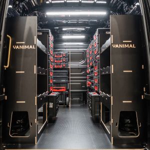 Rear van view of the MAN TGE 2017+ Milwaukee Packout Trolley Compatible Van Racking (x4 V2) displayed with Milwaukee toolboxes and trolleys