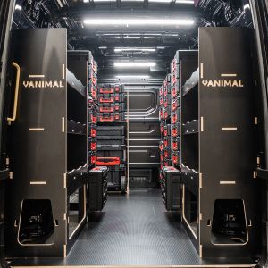 Rear van view of the VW Crafter 2017+ Milwaukee Packout Trolley and Toolbox Van Racking (x4 V2) displayed with Milwaukee Packout toolboxes and trolley