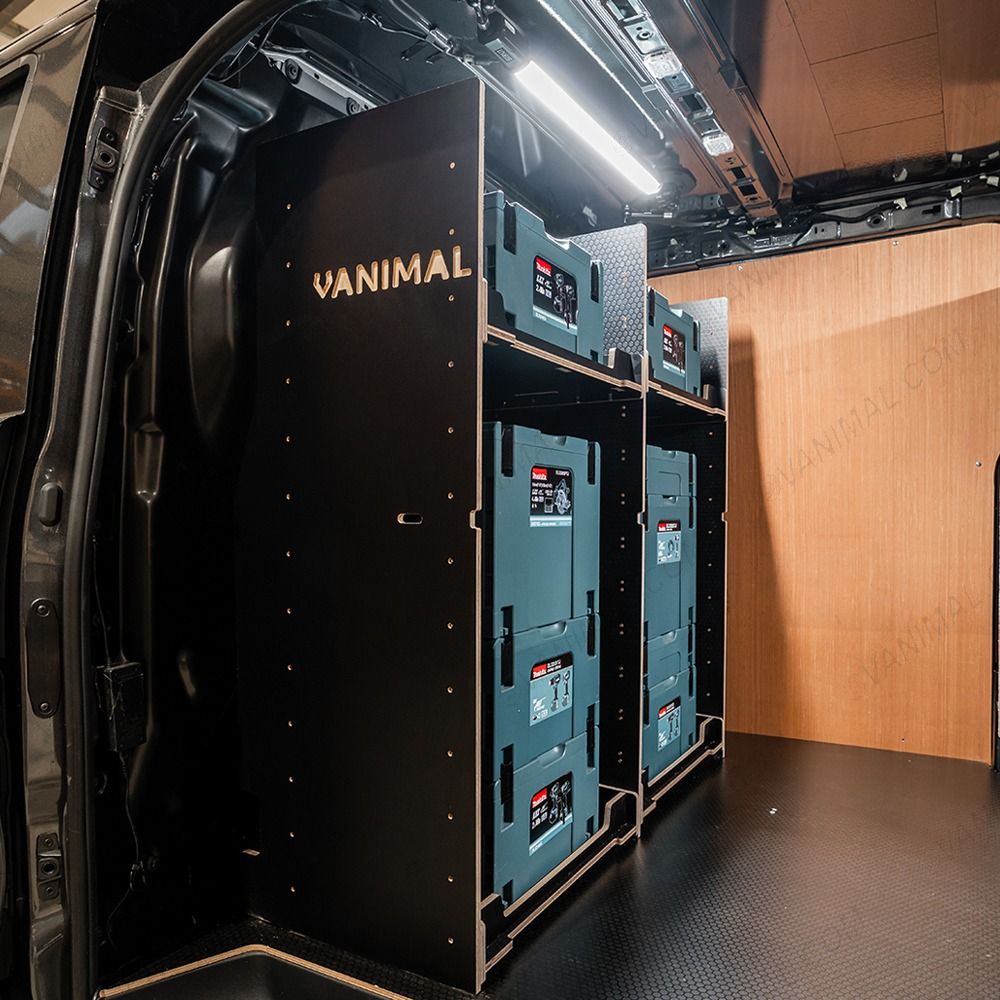 Side van view of the bulkhead section of the Kia PV5 Cargo Makita Makpac Toolbox Compatible Van Racking (x3 V1) displayed with Makita toolboxes and top tray