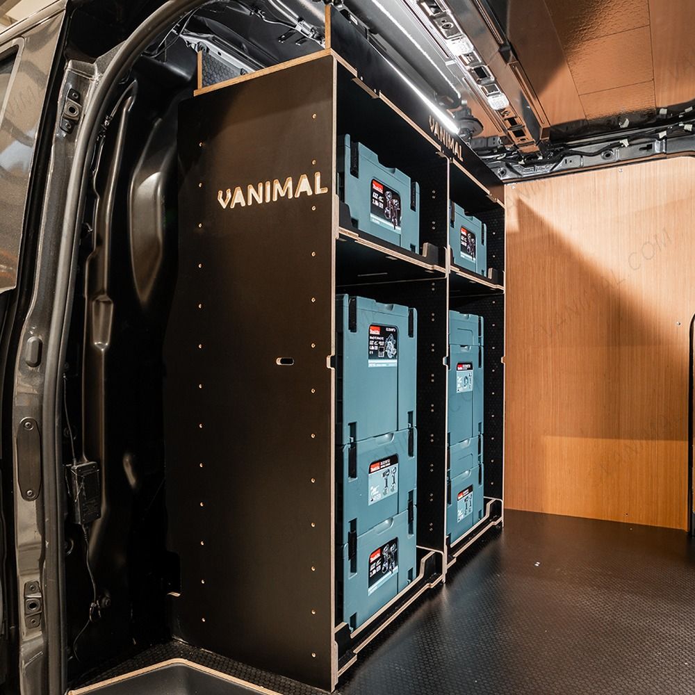 Side van view of the bulkhead section of the Kia PV5 Cargo Makita Makpac Toolbox Compatible Van Racking (x3 V1) displayed with Makita toolboxes and top tray