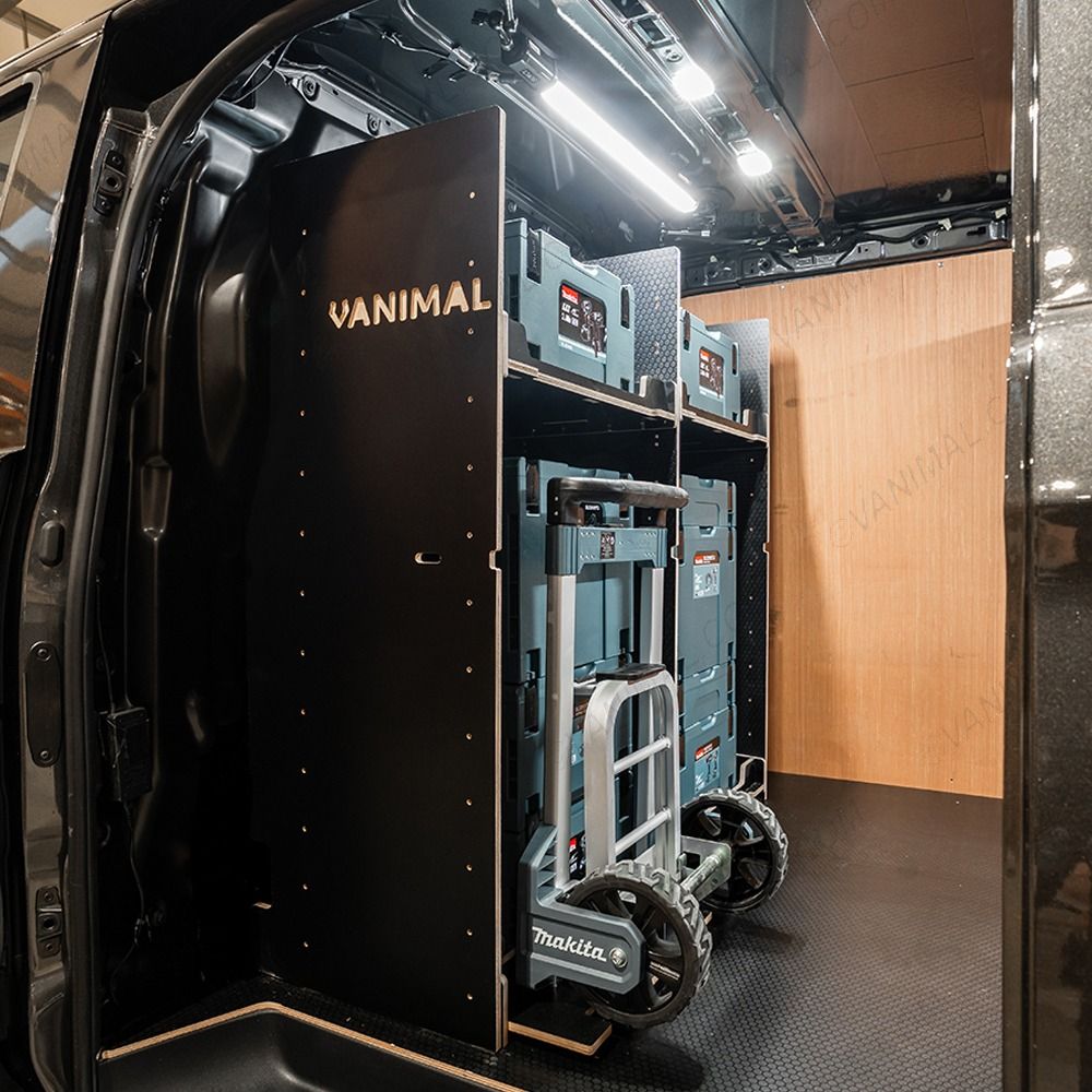 Side van view of the Kia PV5 Cargo Makita Makpac Trolley Compatible Van Racking - Bulkhead displayed with Makita toolboxes and trolley