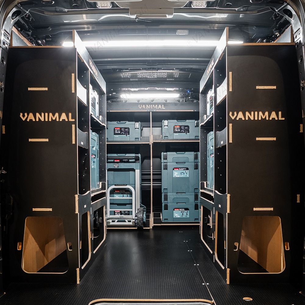 Rear van view of the Kia PV5 Cargo Makita Makpac Trolley Compatible Van Racking (x3 V1) displayed with Milwaukee toolboxes, trolley and top trays