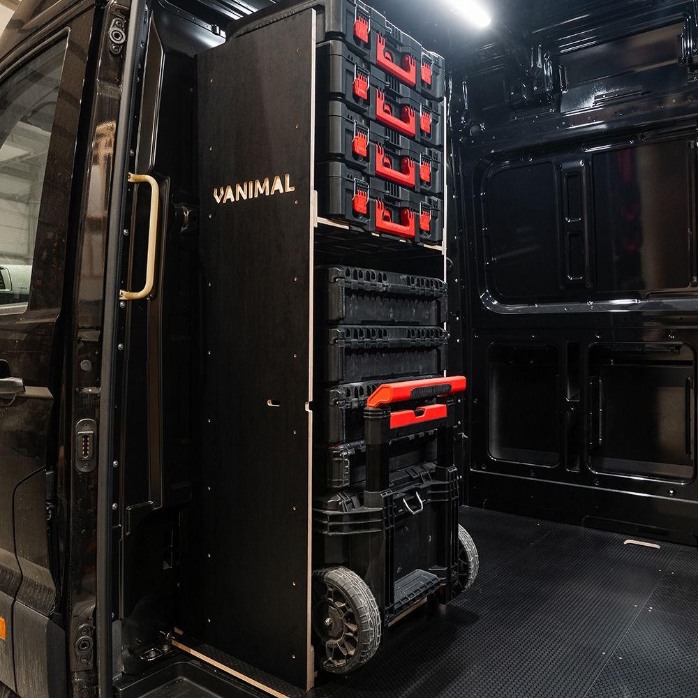 Side van view of the VW Crafter 2017+ Milwaukee Packout Trolley Compatible Van Racking - Bulkhead displayed with Milwaukee toolboxes and trolley