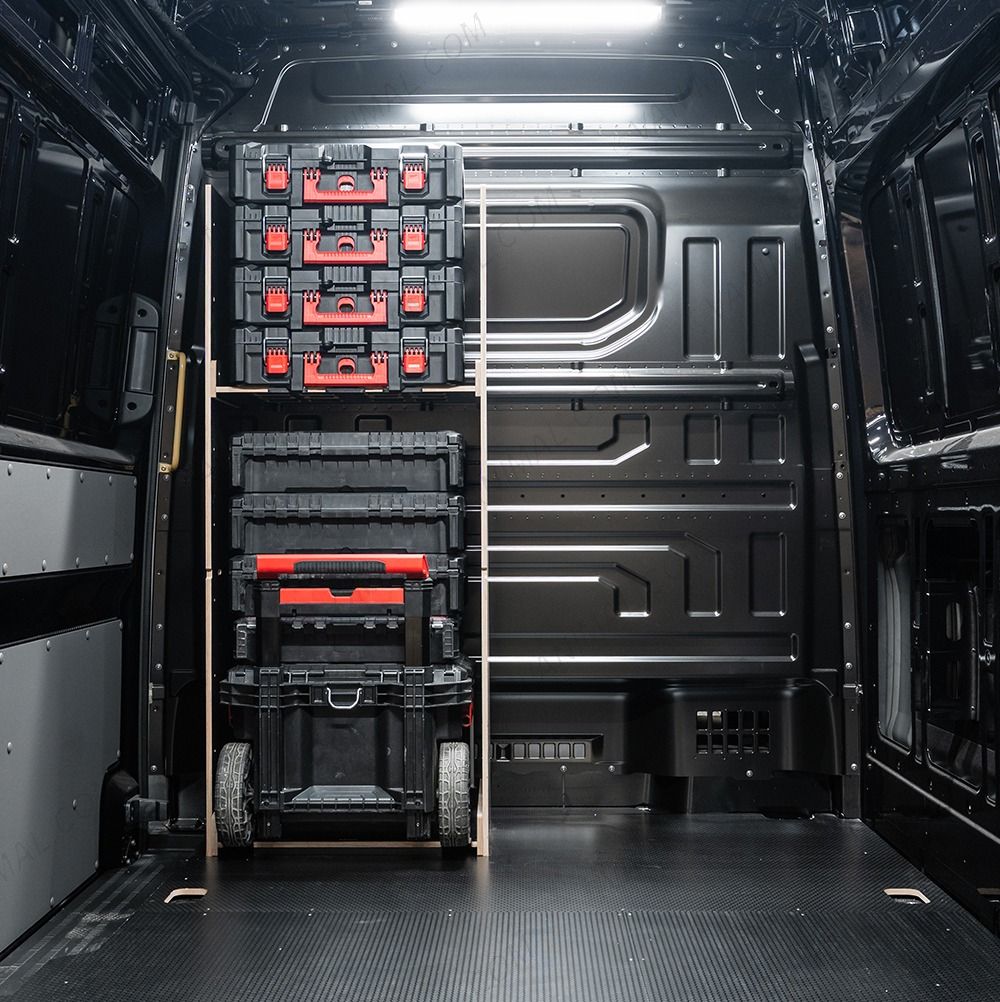 Rear van view of the VW Crafter 2017+ Milwaukee Packout Trolley Compatible Van Racking - Bulkhead displayed with Milwaukee toolboxes and trolley